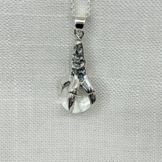 Capture your inner strength with this beautiful Sterling Silver Claw of the Dragon Necklace. The intricate scales and details of the dragon's claw are oxidized to bring out its features, while a 1.2cm quartz crystal ball is held in its grip. At 3.8cm, the pendant is of high-quality and has a luxurious weight to it. The necklace comes on a 20" sterling silver chain and comes packaged in an elegant gift box. Total weight of necklace 8.3g or 0.29oz