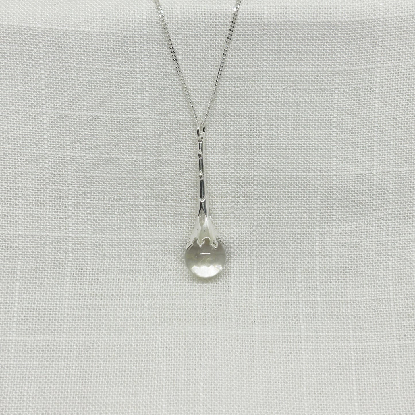 This beautiful crystal ball scrying wand necklace is set in 925 silver. Parts of the wand have been carved in places to allow the light to shine down through the wand to give the quartz crystal ball more clarity. The pendant is approximately 4.5cm long including the bale with the crystal ball measuring 1.2cm in diameter. The pendant comes complete on a 20 inch sterling silver chain and arrives in a tarnish proof bag inside a gift box.