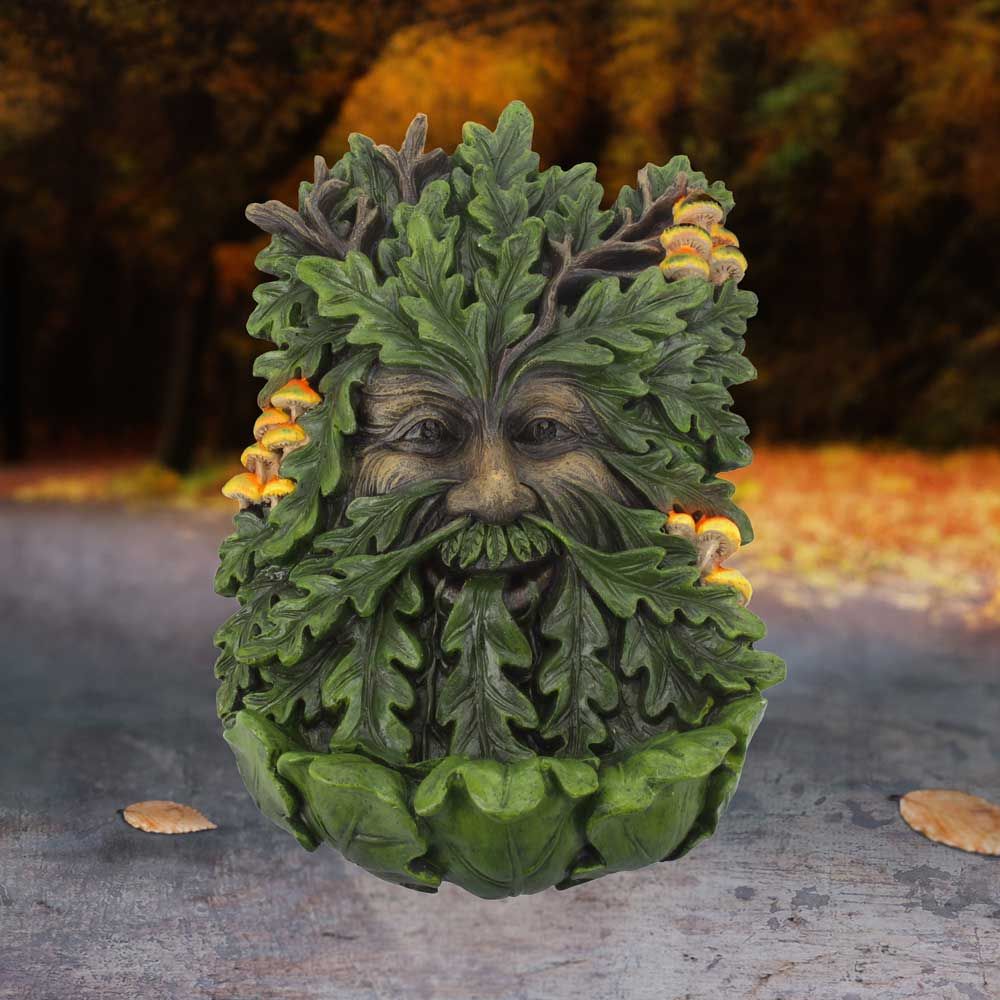 Show your love for ancient shepherds of the forest with this wall mounted tree spirit. His jubilant face is formed from the bark of an aged oak tree and covered in fresh, green leaves and small clusters of toadstools. He symbolises nourishment, transformation, sustenance, spiritual growth, union and fertility. Height 24cm Width 15cm Depth 7cm