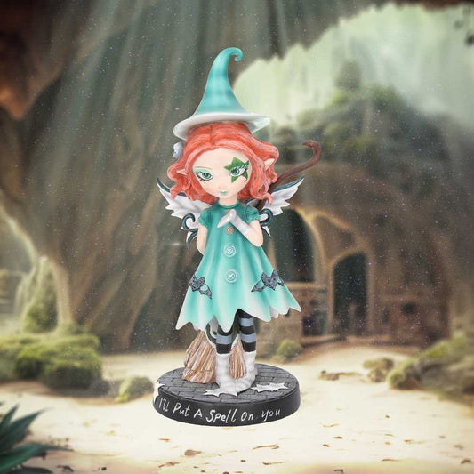 Wearing a turquoise dress and pointed hat, this unique fairy has a pair of delicate white wings emerging from her back. Her light auburn hair frames her face which is decorated by a large star. In her hand, she holds a broomstick while spreading a little magic with the other. The theme behind the figurine is emblazoned on the black base, 'I'll Put A Spell On You'.