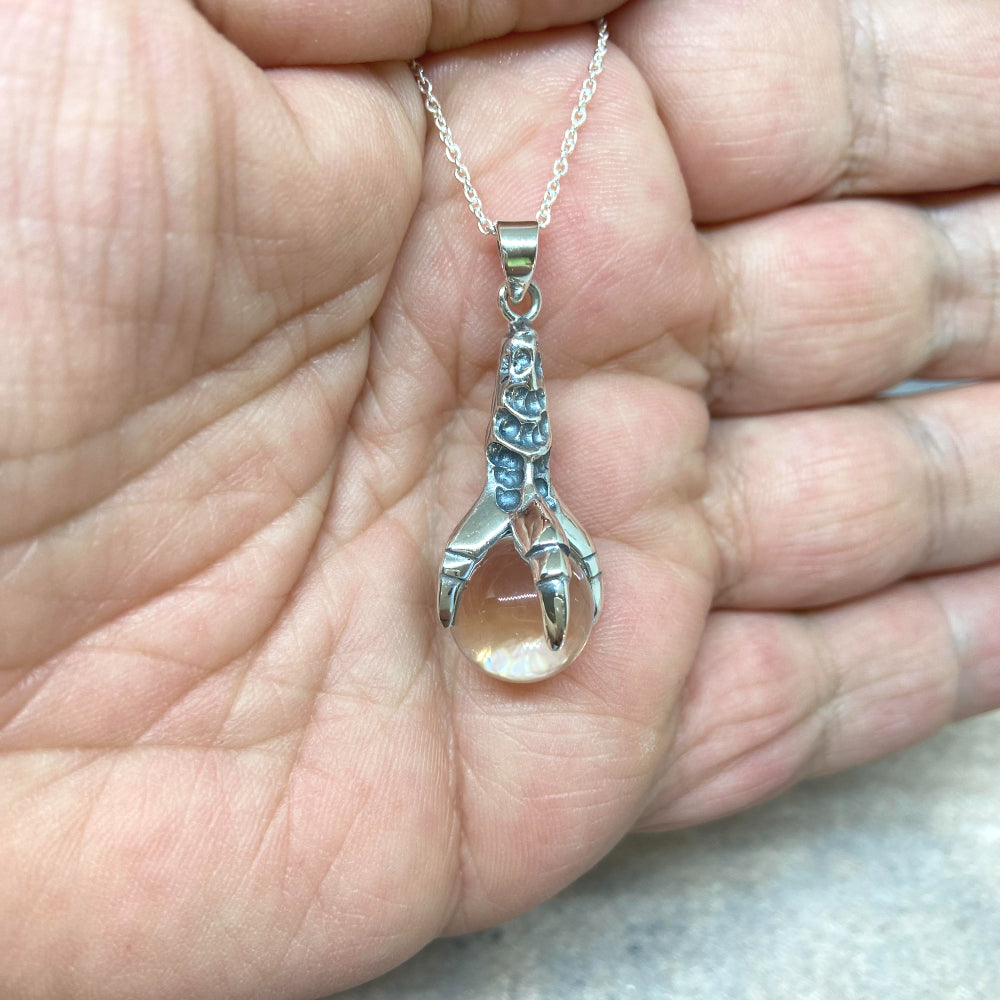 Capture your inner strength with this beautiful Sterling Silver Claw of the Dragon Necklace. The intricate scales and details of the dragon's claw are oxidized to bring out its features, while a 1.2cm quartz crystal ball is held in its grip. At 3.8cm, the pendant is of high-quality and has a luxurious weight to it. The necklace comes on a 20" sterling silver chain and comes packaged in an elegant gift box. Total weight of necklace 8.3g or 0.29oz