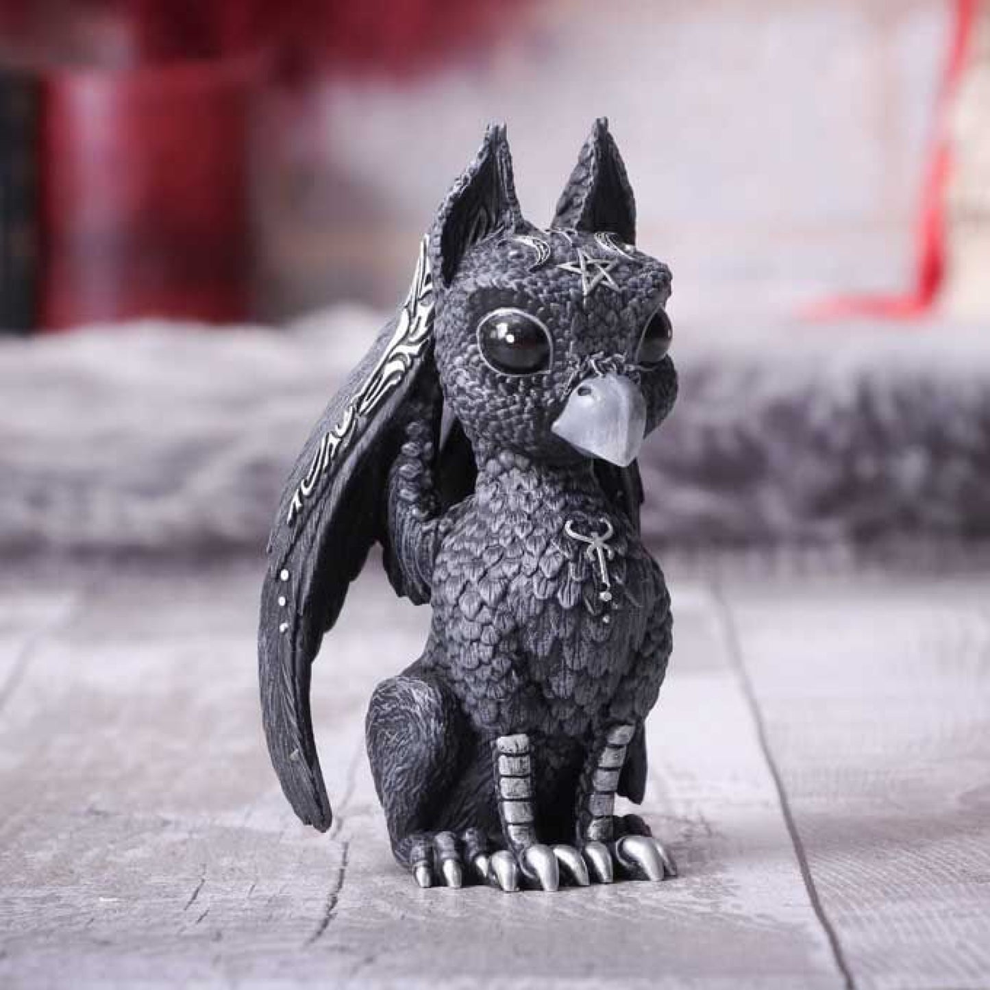 Griffael is the latest addition to the Cult Cutie family. The griffin, griffon, or gryphon is a legendary creature with the body, tail, and back legs of a lion, the head and wings of an eagle; and sometimes an eagle's talons as its front feet. Featuring occult symbology and ornate silver detailing, this beautiful baby griffin gazes proudly out at all those who pass by.