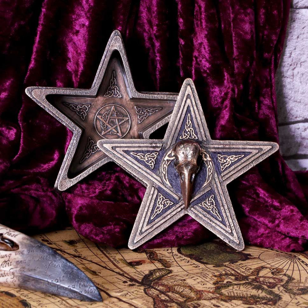 Shaped into a pentagram, this box features a variety of witchcraft symbols and Celtic knot work both inside and out. On the lid of the box sits the skull of a raven, which can be lifted to reveal your most prized possessions. Cast in the finest resin before being expertly hand-painted, this box makes for the perfect addition to any Witch's collection.