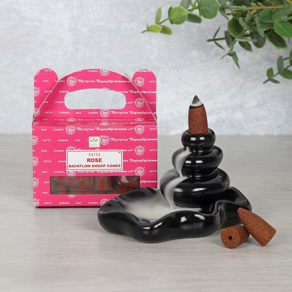 This box contains beautifully scented Rose backflow incense cones developed by Satya. The cones are crafted using the highest quality ingredients to offer long lasting fragrance. Use these cones with a backflow incense burner to create stunning smoke displays. Always use backflow cones and burners on a non stainable surface.