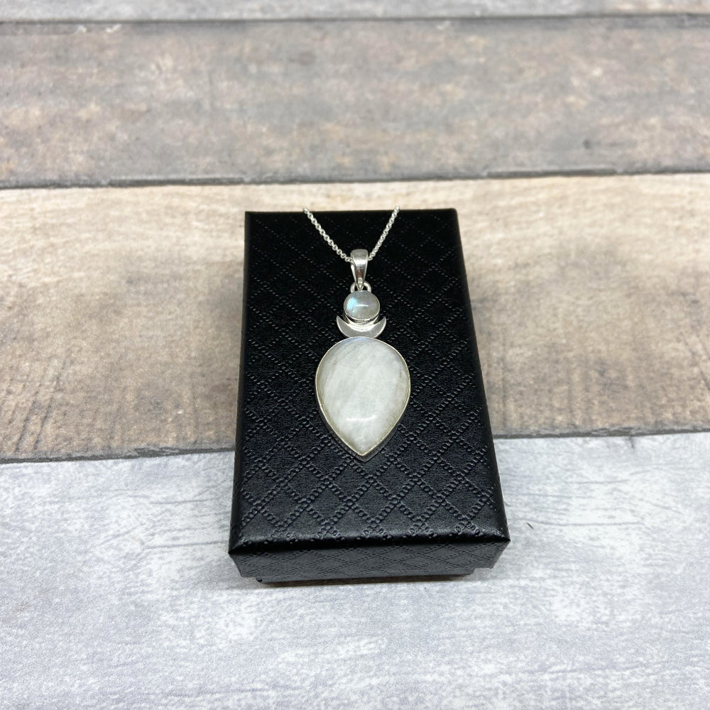 This larger sized pendant set with two rainbow moonstone cabochons, one above and a larger one below with a silver crescent moon between them. Set in 925 Sterling Silver it measures approx 5cm in length (inc bale) x 1.8cm in width. The weight of each pendant is at least 8.8 grams. These pendants come complete with a 20" Sterling Silver Curb Chain and arrive in a tarnish proof bag inside a gift box.