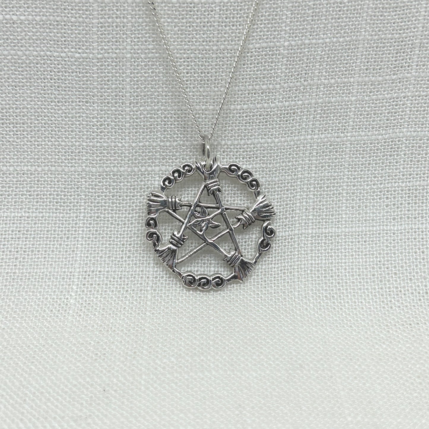 This pendant is a best seller with its detailed Besoms or Broomsticks of Elder in a Pentacle design encased in a Blackberry Vine circle with an Elder leaf in the centre. Approximately 2.9cm in long including the bale by 2.6cm wide. All pendants come supplied on a 20 inch Sterling Silver Curb Chain and are gift boxed. 