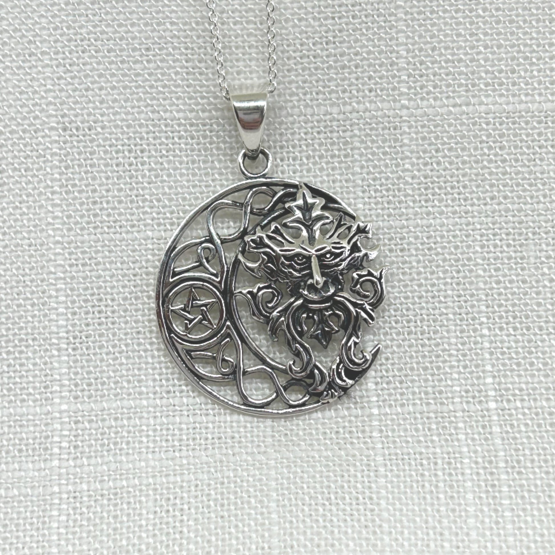 This 925 silver pendant features a Celtic knot style crescent moon with a pentacle within its centre. Filling the space in the moon is a gorgeous Green Man, the mysterious Pagan God who is a protector of all wildlife, woodlands and nature that dates back to medieval times. He is also known by many other names such as Jack o' the Green, Cernunnos, John Barleycorn and Herne of the Hunt. The pendant is approximately 3.6cm long including the bale by 2.6cm wide. Total weight is 7g.