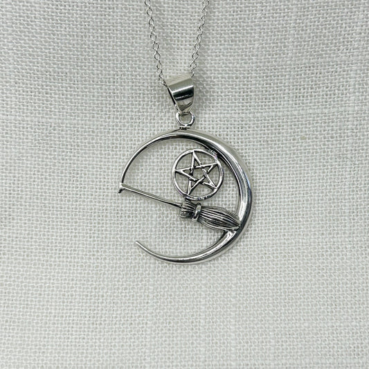 Inside this crescent moon necklace features a Witches' broomstick or besom (pronounced bee-som) along with a pentacle. With a slightly oxidised finish to show off the detail perfectly, this necklace is a best seller among the Witch community. Pendant size is 3.2cm long including the bale x 2.7cm wide. All jewellery comes complete on a 20" sterling silver chain and arrives in a tarnish proof bag and gift box.
