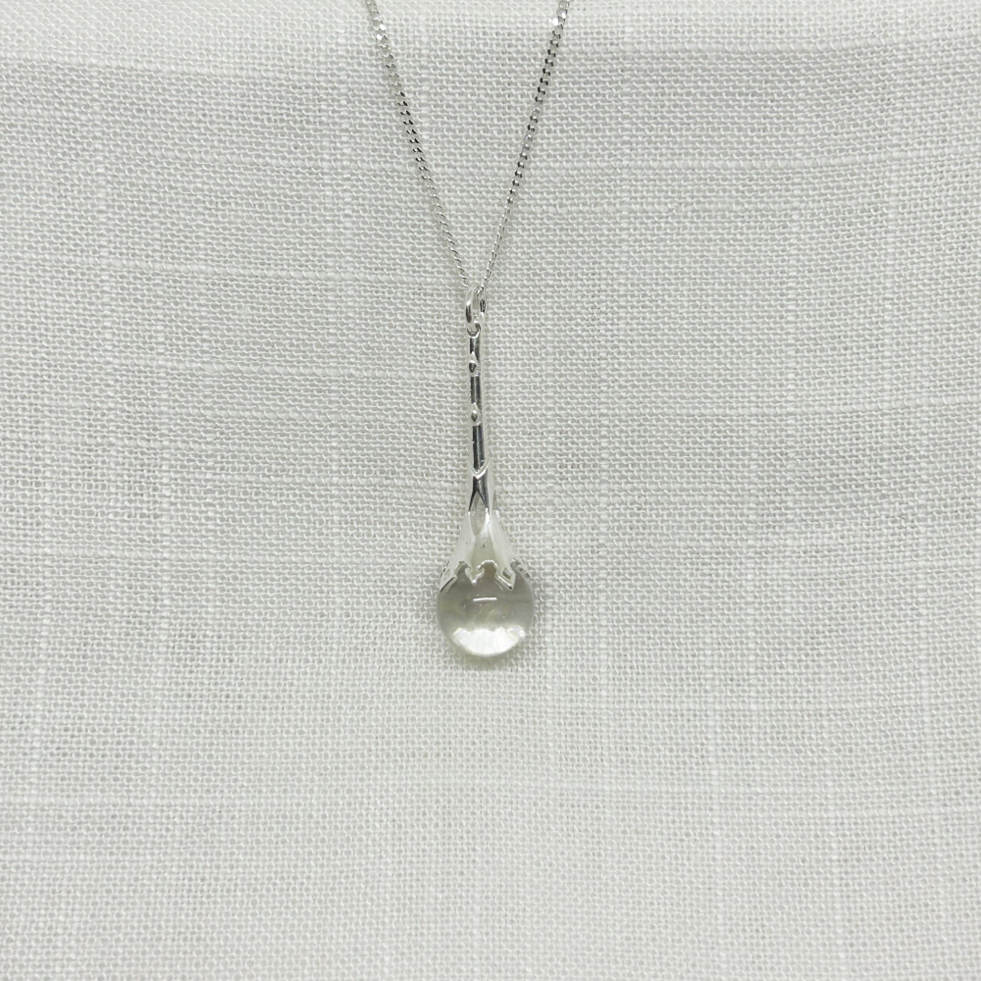 This beautiful crystal ball scrying wand necklace is set in 925 silver.  Parts of the wand have been carved in places to allow the light to shine down through the wand to give the quartz crystal ball more clarity.  The pendant is approximately 4.5cm long including the bale with the crystal ball measuring 1.2cm in diameter.  The pendant comes complete on a 20 inch sterling silver chain and arrives in a tarnish proof bag inside a gift box.
