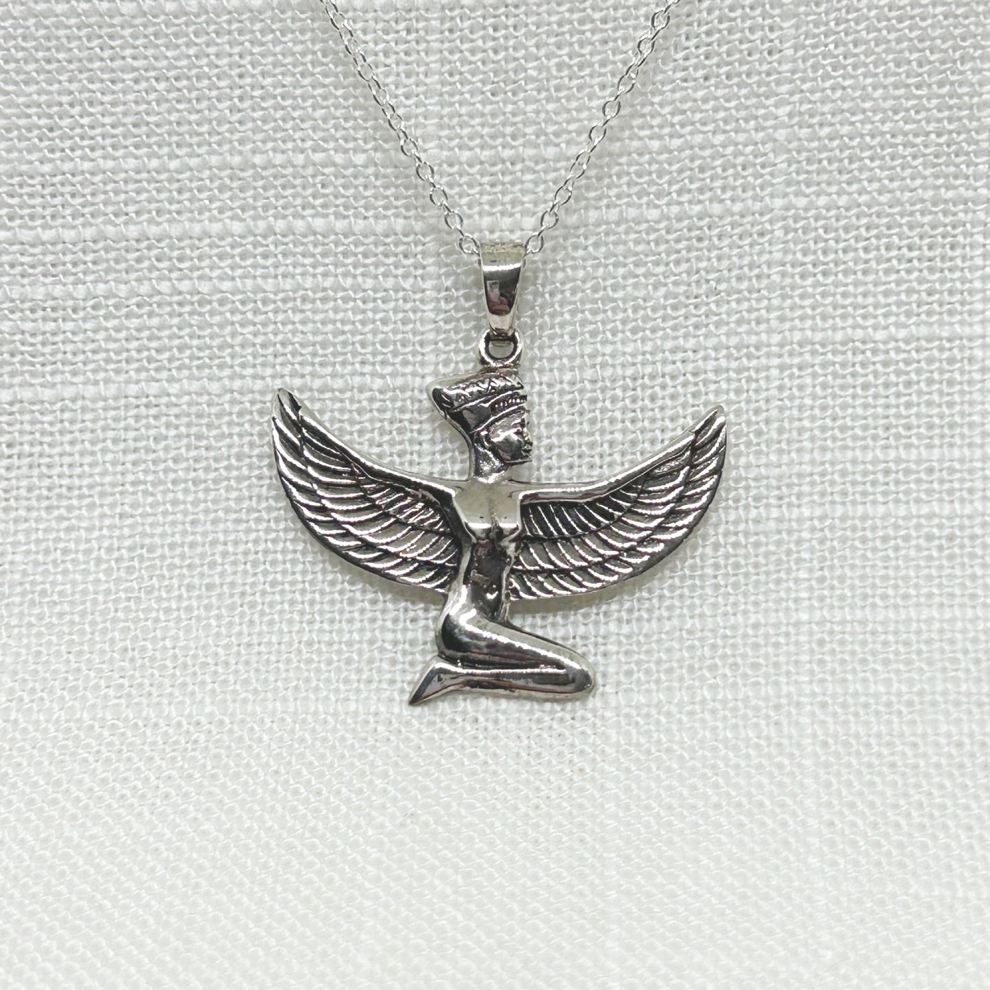 Set in solid 925 silver, this beautiful ancient Egyptian Goddess Isis is kneeling with detailed wings that spread 3cm wide. She is 3cm high including the bale.  All pendants come supplied on a 20 inch Sterling Silver Curb Chain and arrive gift boxed.   In ancient Egypt, Isis symbolises motherhood, healing, magic, love, death and rebirth.