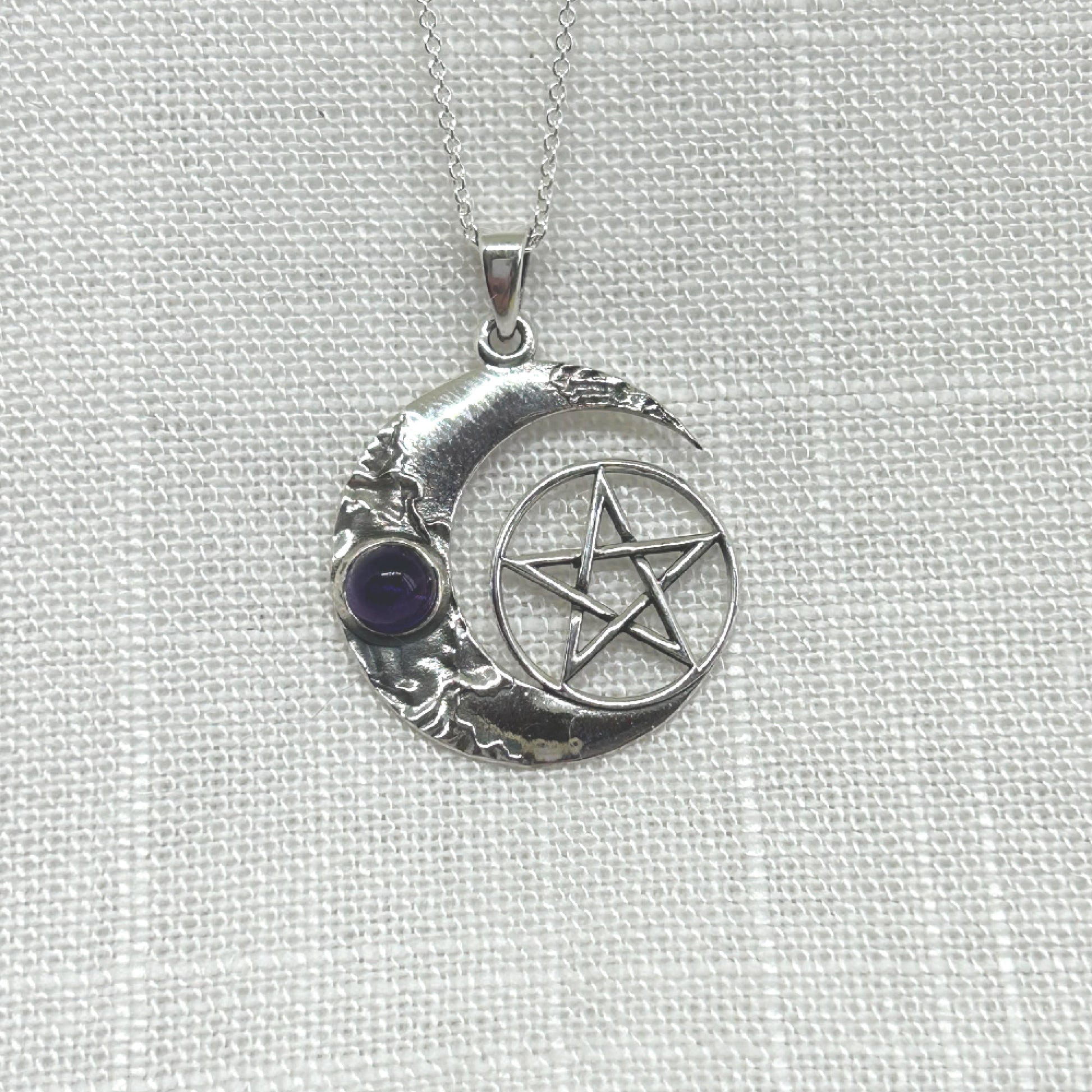 This beautiful, highly polished silver necklace features a crescent moon with an amethyst cabochon and a pentacle symbol.   Size approx: W: 2.4cm x H: 3.1cm including bale. Total weight is 4.8g  All pendants come supplied on an 20 inch .925 Silver Curb Chain and arrives in a tarnish proof bag inside a gift box.