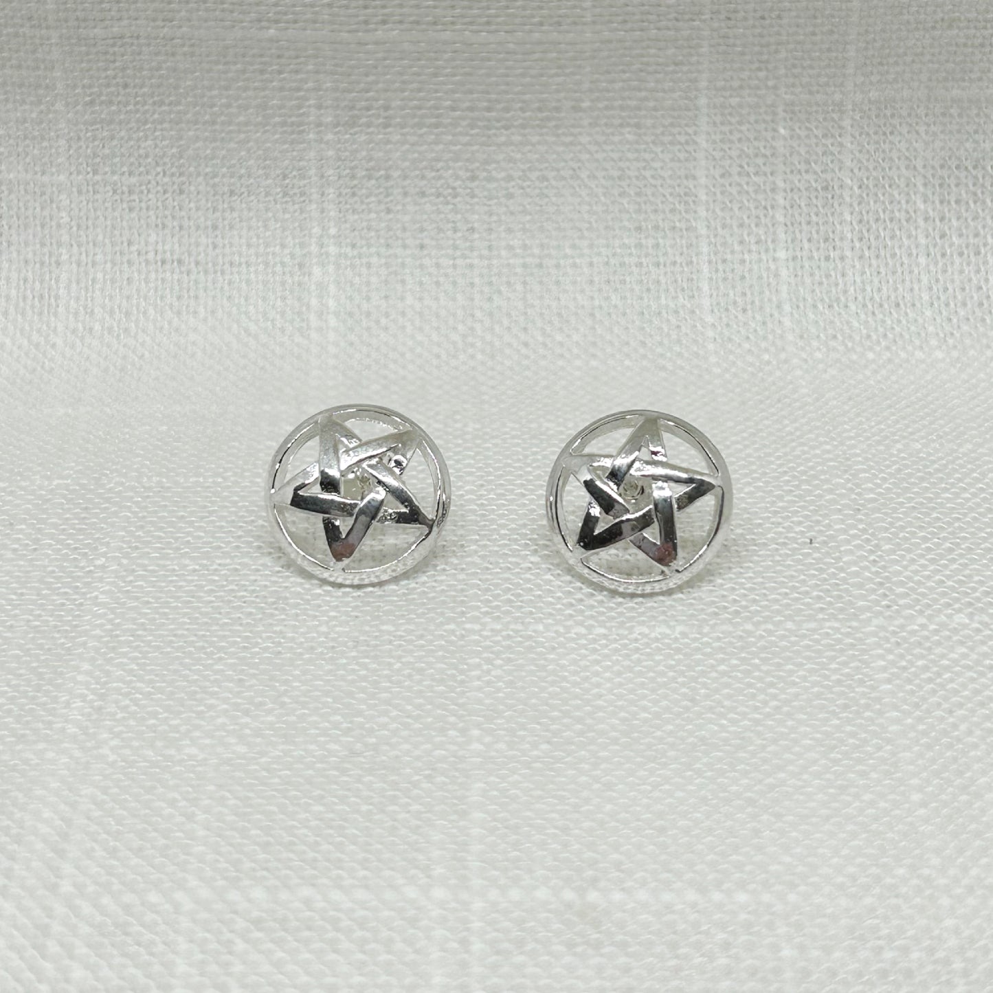 These 925 silver pentacle (a pentagram within a circle) stud post earrings are slightly domed with a high polish. The size of these are 1.1cm in diameter. All jewellery comes gift boxed. Earrings are non returnable due to hygiene laws.