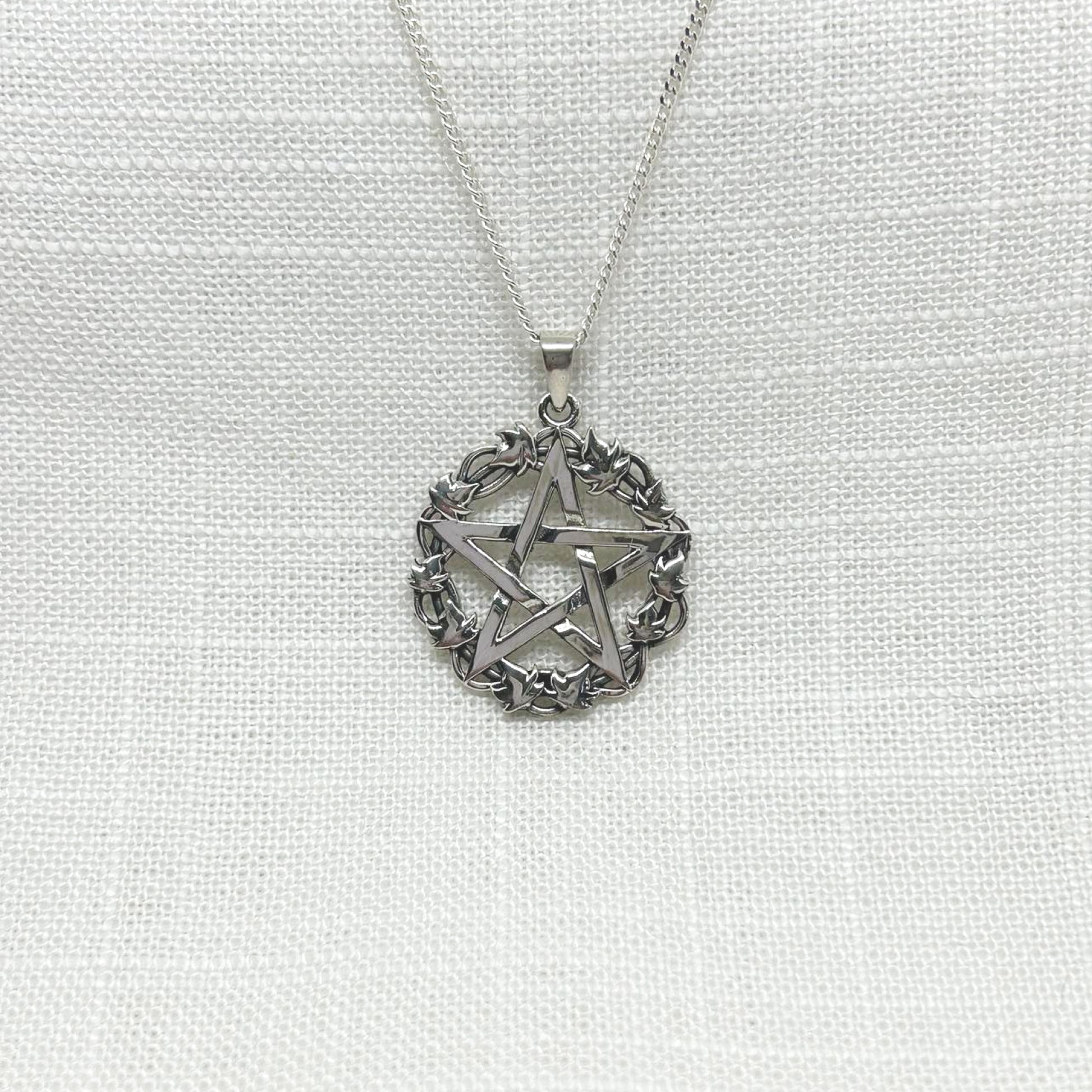 This beautiful solid .925 silver pentagram necklace is encircled by ivy leaves. Ivy is the symbolism of fidelity. Because ivy grows in the shape of a spiral, it is also considered to be associated with the Goddess and guards against negativity. All pendants come supplied on an 20" Sterling Silver Curb Chain and are gift boxed. Size approx: W: 2.9cm x H: 3.2cm including bale