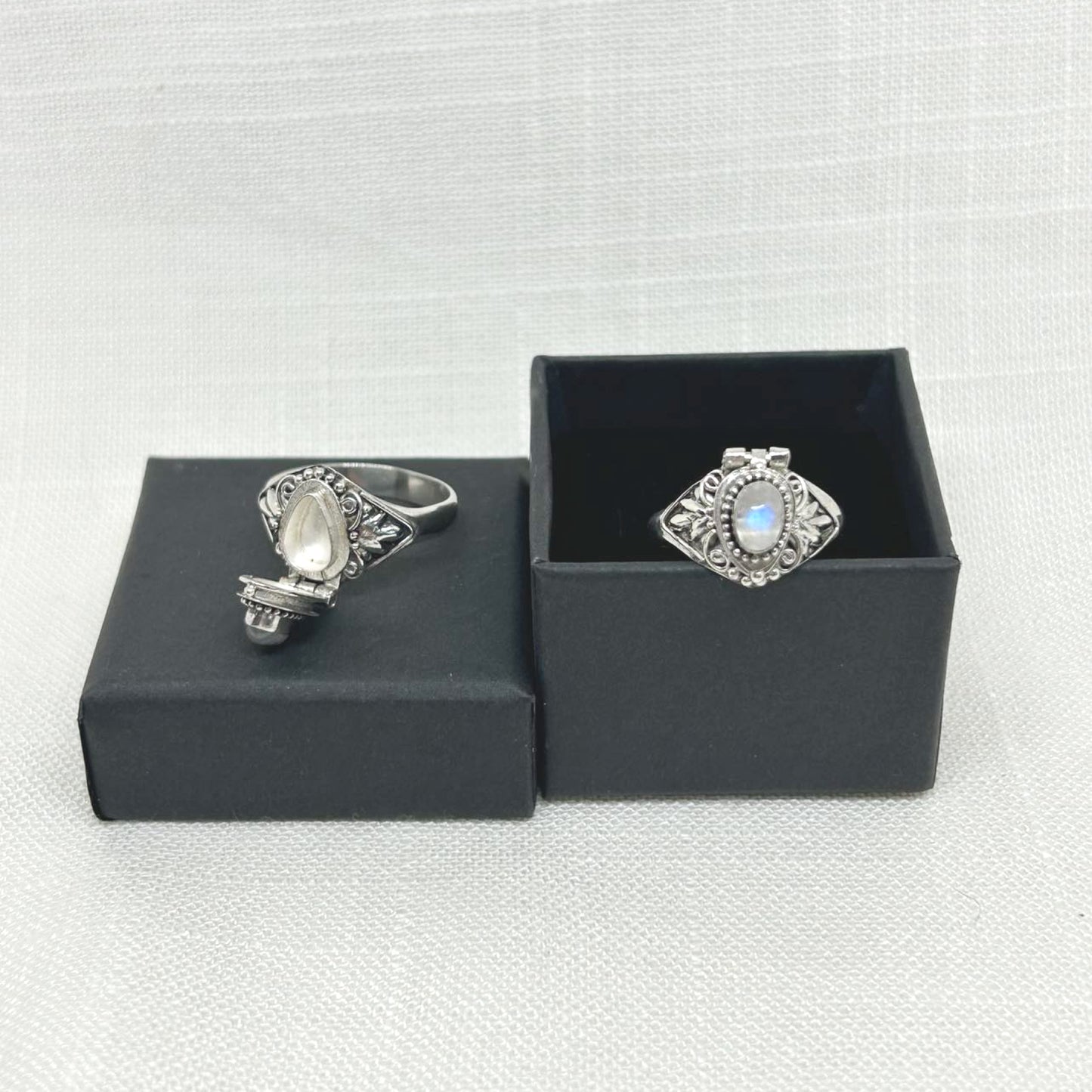 A beautifully patterned hand made poison ring with an oval Rainbow Moonstone sitting on the top. The crystal is approx 7mm long by 5mm wide. Total length of the ring is approx 15mm. The hidden box sits on top of the ring with a functioning lid to hold small objects or the old days, a small amount of poison. All jewellery comes gift boxed.