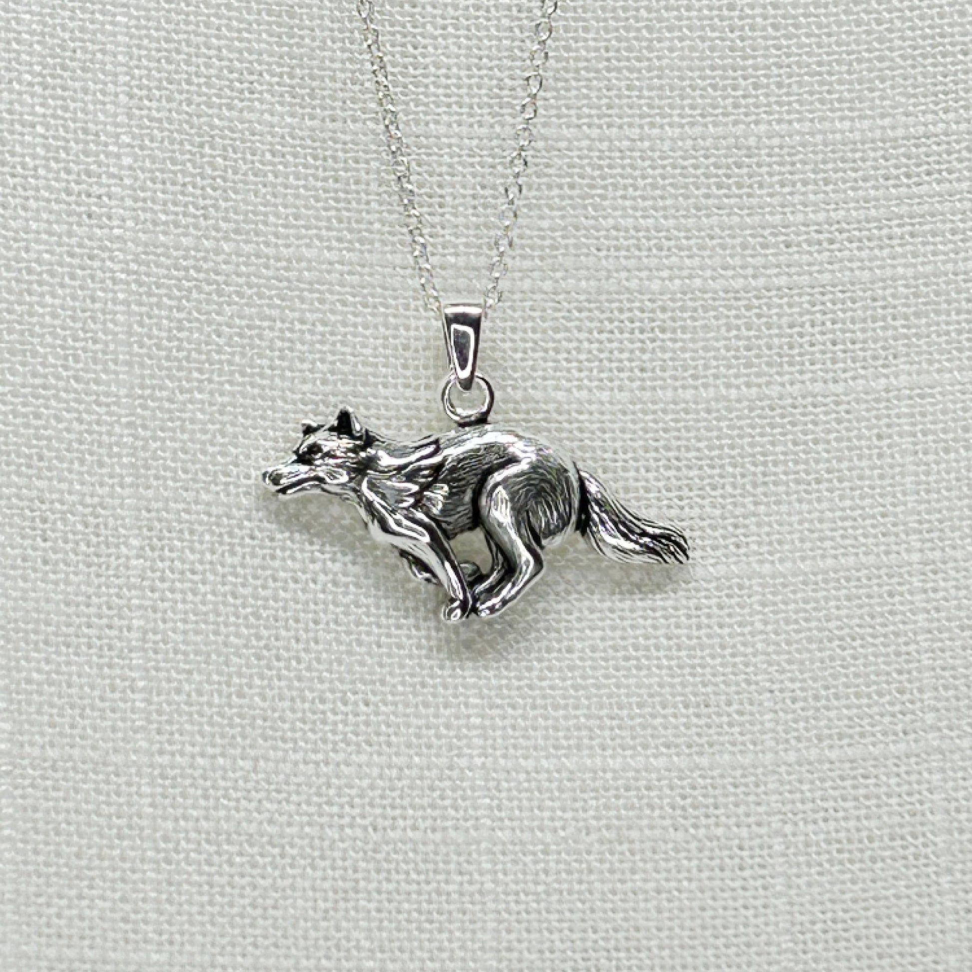 This beautiful heavier weight wolf familiar looks as though he is running, maybe to join the rest of his pack! He has a bushy tail and has been slightly oxidized to show off the detail of his fur. The pendant is approx 3cm long by 2.1cm high including bale and comes supplied on an 18 inch sterling silver cable chain. All jewellery comes gift boxed.