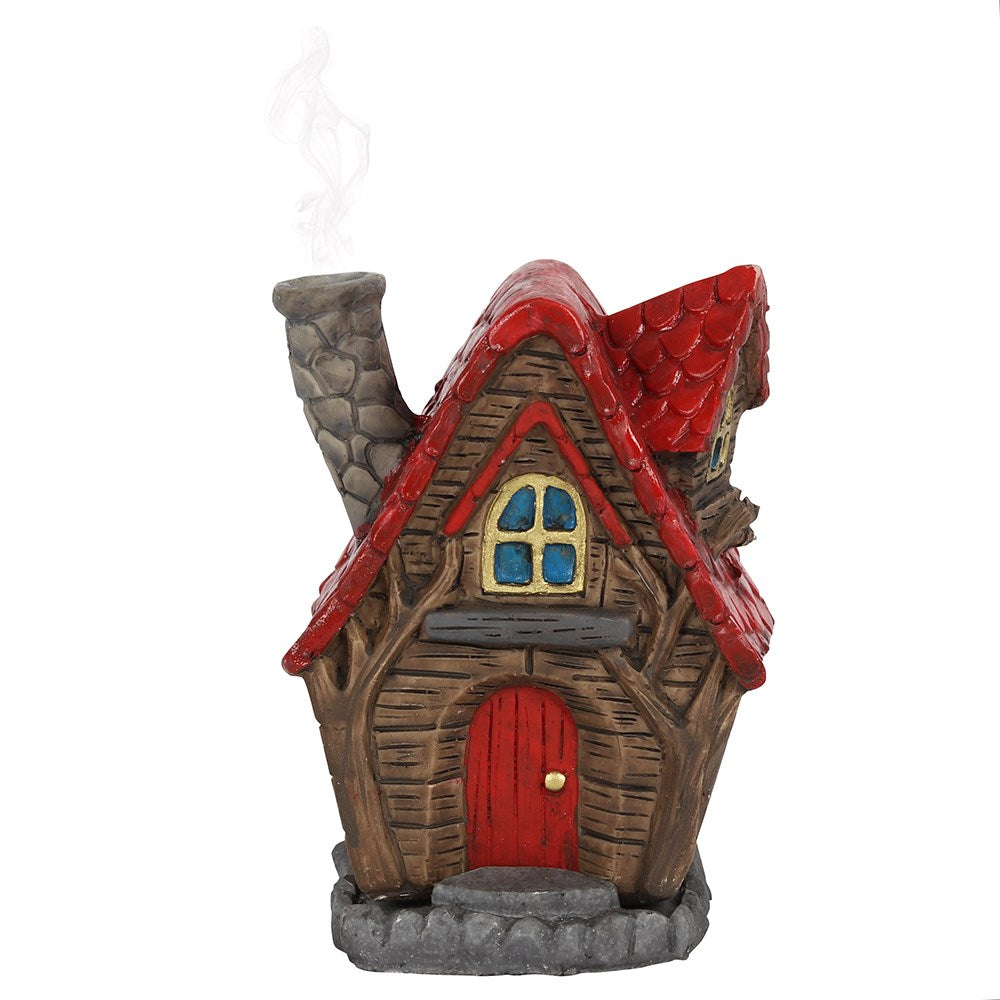 A magical 'wooden' style fairy house incense cone burner with a red tiled roof and matching front door. When the cone is burning, the smoke rises from the chimney. Each comes with its own picture box. Designed by Lisa Parker. Material: Polyresin Size: H: 12cm W: 10cm D: 7cm