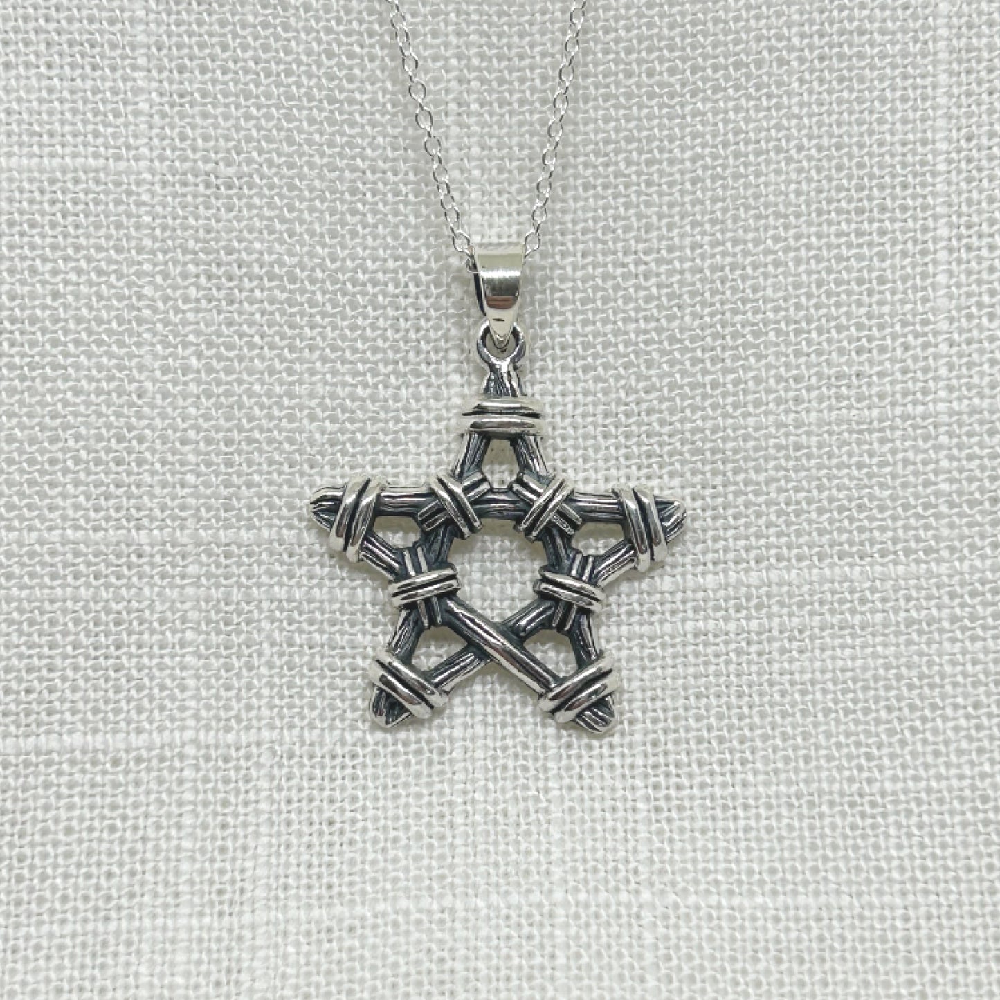 This beautifully crafted 925 silver pentagram necklace design is made by twigs and bound together with twine to create a realistic rustic look. Size is approx 3cm including the bale. It comes complete with a 20" sterling silver curb chain and is gift boxed.