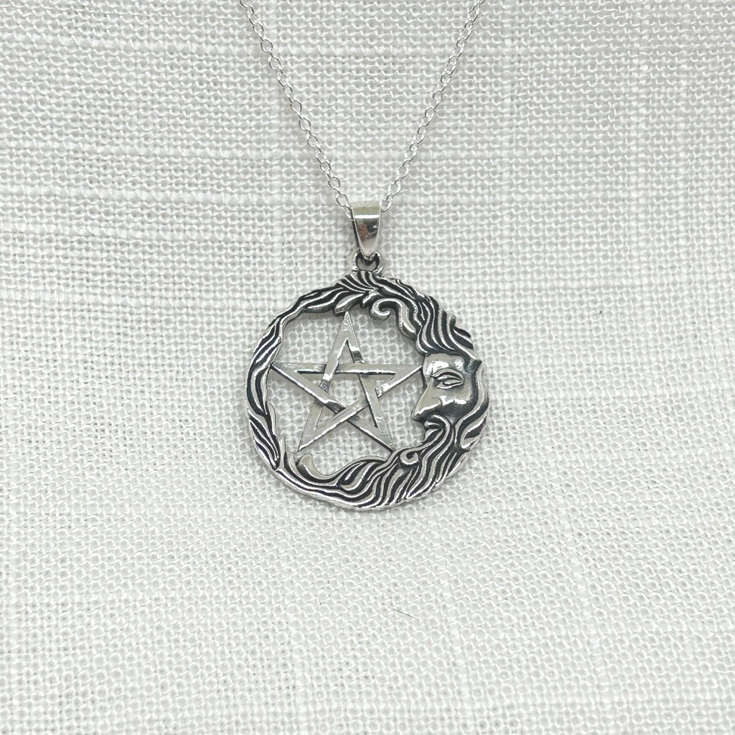 This stunning unisex crescent shaped wise man is sat in front of a pentagram with his beard and hair circling around the pendant. Size approx: H: 3cm incl bale x W: 2.4cm. All pendants come supplied on a 20" Sterling Silver Curb Chain and are gift boxed. This design is also available with a tree of life