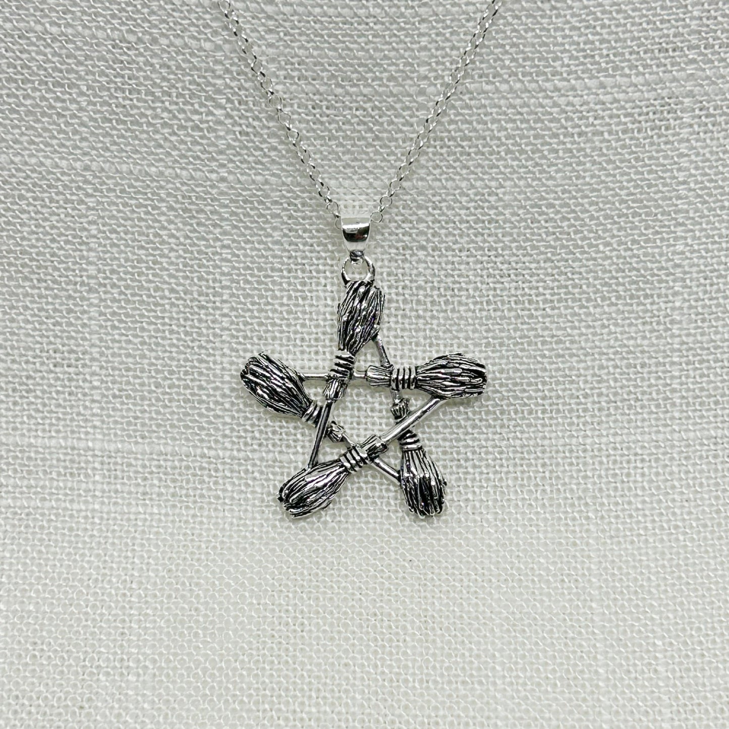 This pentagram pendant is just over 3cm long including the bale.   The 5 besoms (pronounced 'bee-som' is a traditional Witches' broomstick) have been slightly oxidized to show the detailing.   The pendant comes complete on a 20" sterling silver chain and arrive in a tarnish proof bag inside a gift box.  Matching drop earrings are available to buy separately