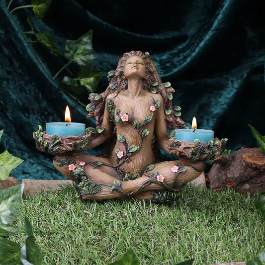 This beautiful guardian of the forest has thick networks of blossoming branches encasing her body. A thick canopy of leaves cascades from her hair as she tilts her head backwards, poised to the sky. She holds two tealights in her slender hands, offering up thanks to the gods of the forest. Cast in the finest resin before being expertly hand-painted, this piece is perfect for those who are at one with nature. Size: H: 19cm Material: Polyresin 