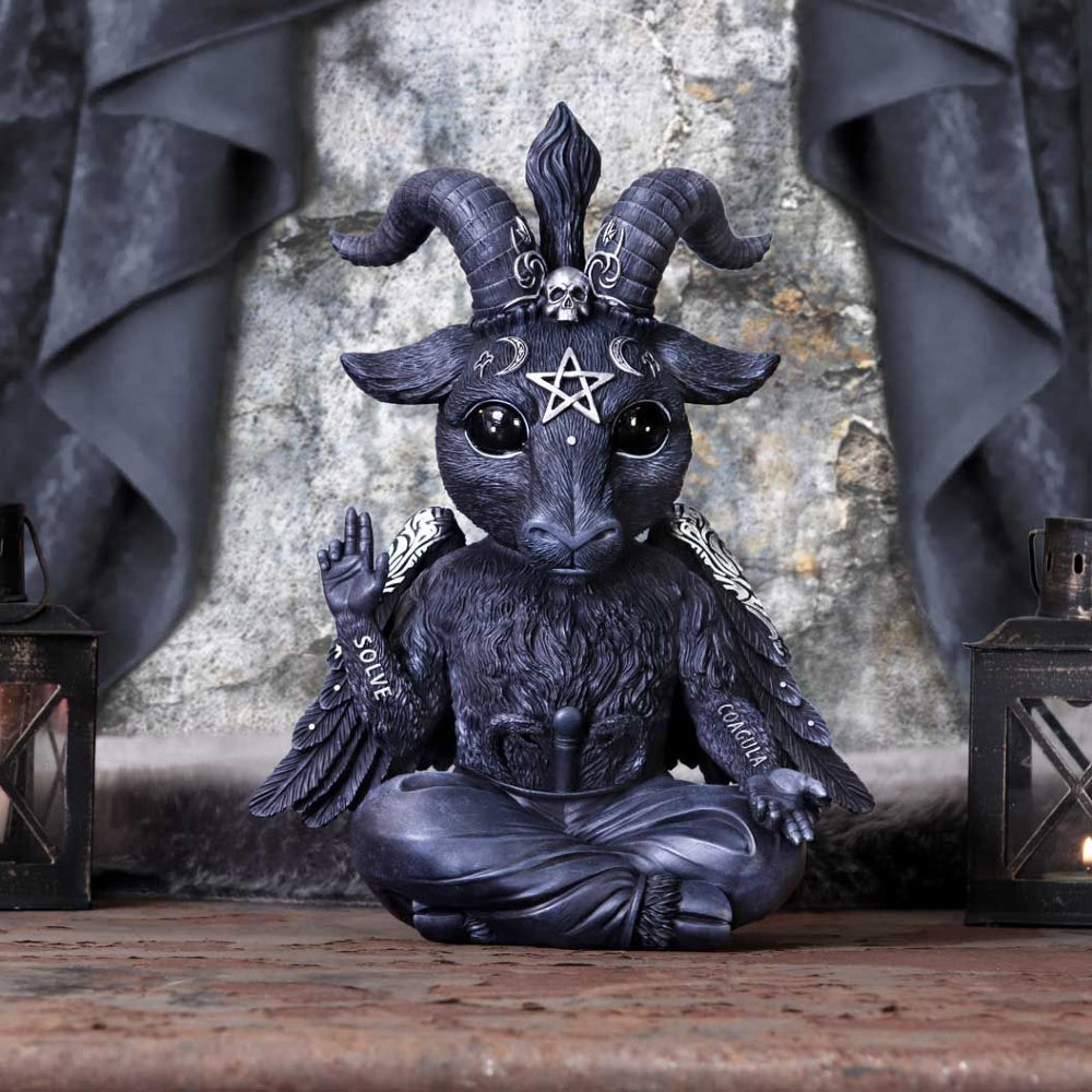 Sitting cross-legged, this Baby Baphomet sits, symbolizing the sum total of the universe. Legs ending in cloven hooves, the staff of Asclepius rises from their crotch. Their right arm is raised in a magical blessing with the word SOLVE (Separate) written on their forearm, while its left arm is stretched downwards and outwards invitingly, forearm bearing the word COACULA (Join Together). Their triple-horned goat’s head stares directly forwards as their wings stretch out behind them. 30cm