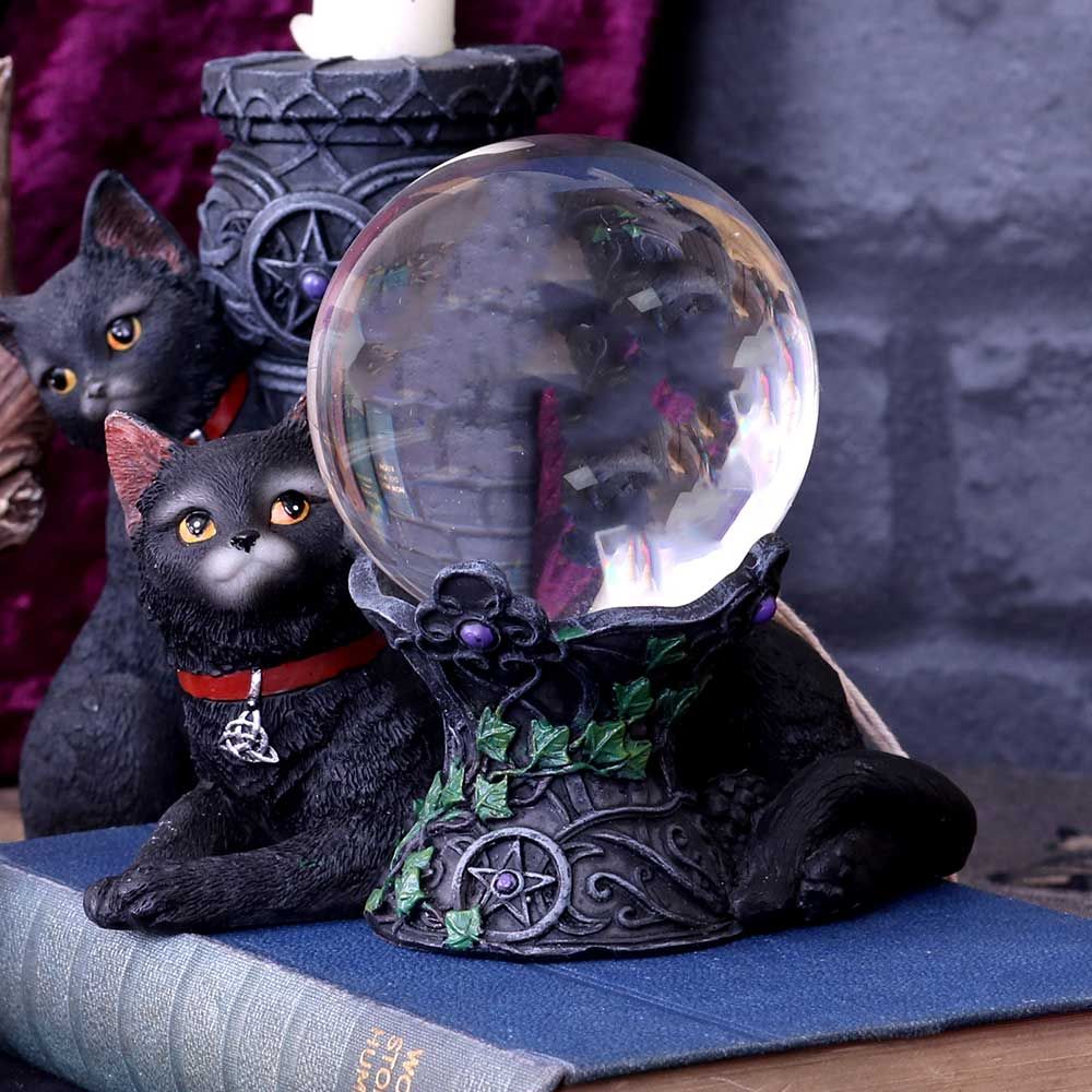 Lying on the ground, this black cat has a silver triquetra medallion hanging from their red collar. They look up with inquisitive eyes, curled around a carved stone pillar. Set with violet jewels in the centre of pentagrams, ivy creeps up around it. A cute companion for the witch in your life. A 7cm crystal ball is included.