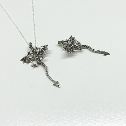 This stunning dragon necklace is set in 925 silver.  The detail on the dragon has been slightly oxidised to show off it's scales, head and wings.  Featuring a hidden bale under the body, when worn it is slightly raised from the neckline.  With wings outstretched, it measures 3cm wide.  From the head to the tip of the tail is 5cm long.  All pendants come supplied on a 20 inch silver chain and arrive in a tarnish proof bag inside a gift box.
