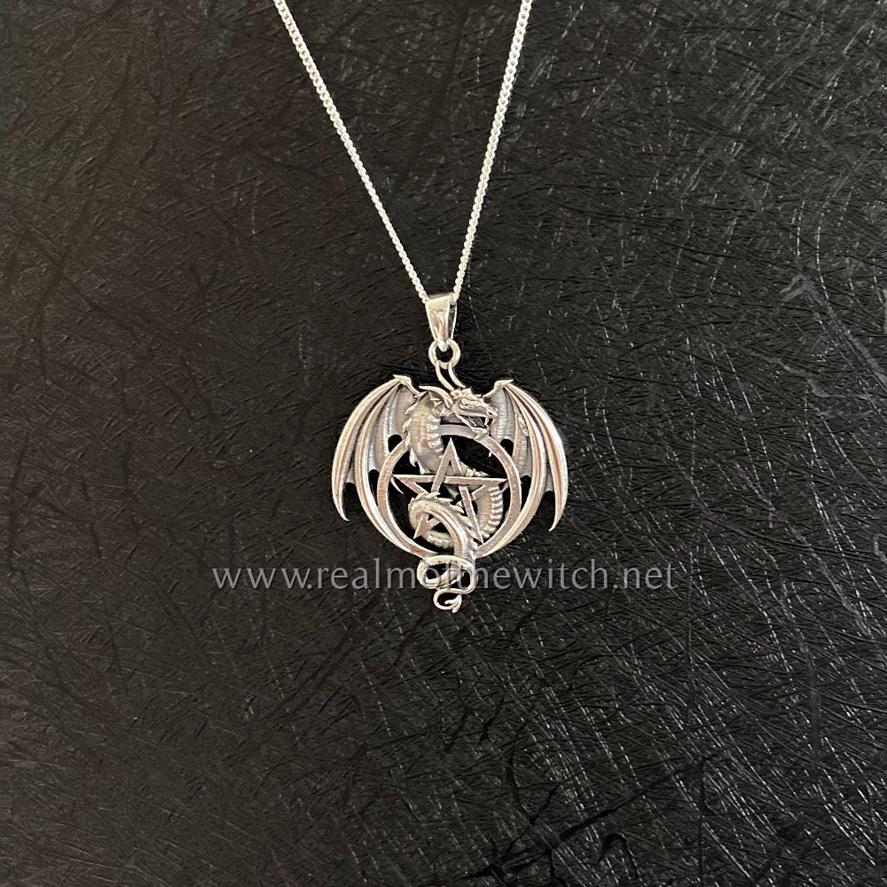 This stunning .925 silver dragon entwines itself within a pentacle, while his wings are semi open. Approx 3.6cm long including the bale x 2.6cm wide. All pendants come supplied on an 20" Sterling Silver Curb Chain and are gift boxed.