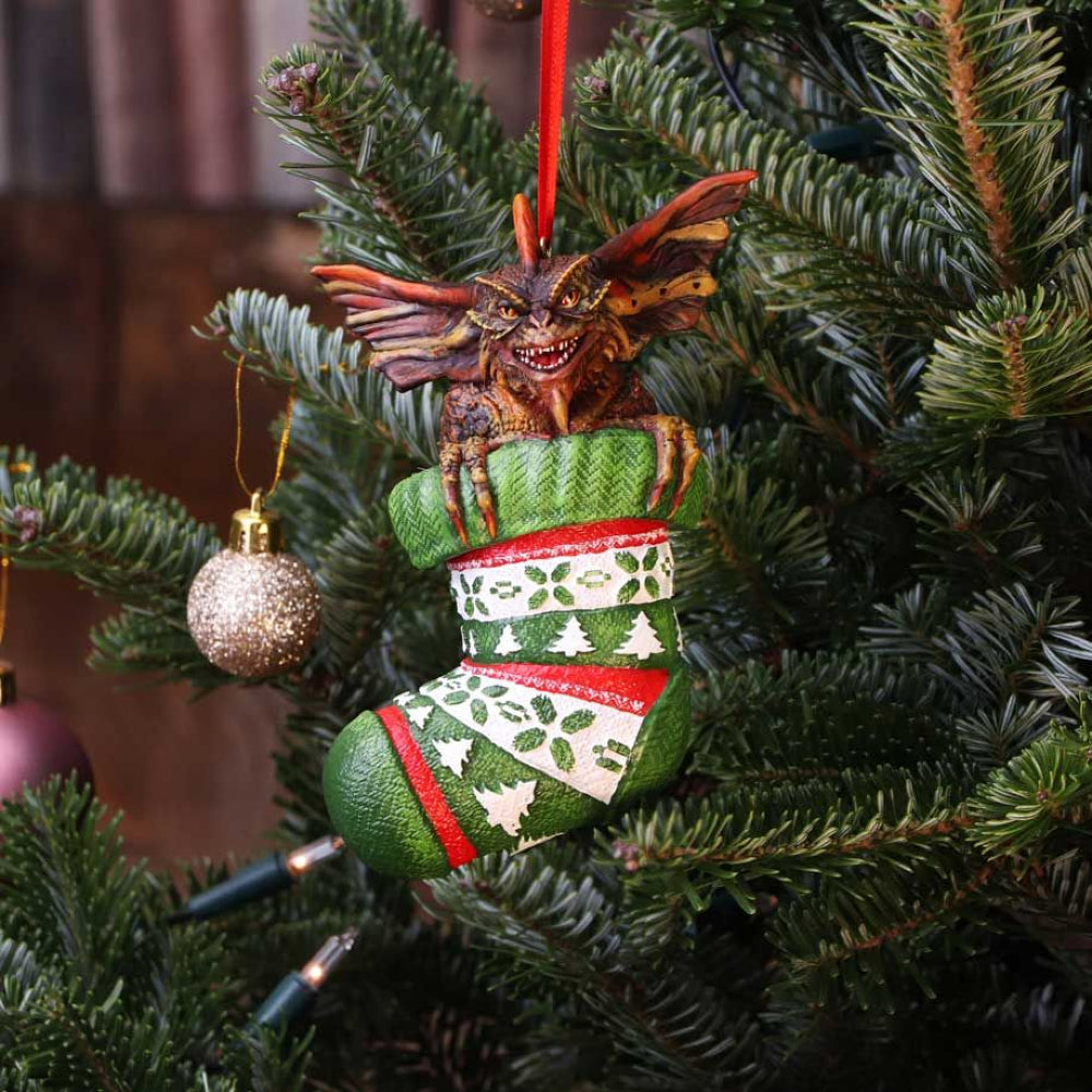 The Gremlins are coming to a tree near you! These hanging tree ornaments will add some colour and festivity to your Yuletide celebrations! Sat in a Christmas stocking with a Santa hat on, he looks ready to cause a riot! Approx 12cm.