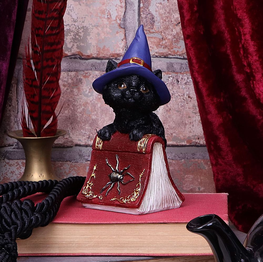 This sweetest little cat figurine is cast in high-quality resin before being hand-painted. Hocus is feeling playful while sitting inside the pages of a crimson spell book. With a red Witches hat on his head, he is the perfect gift for the witch in your life.
