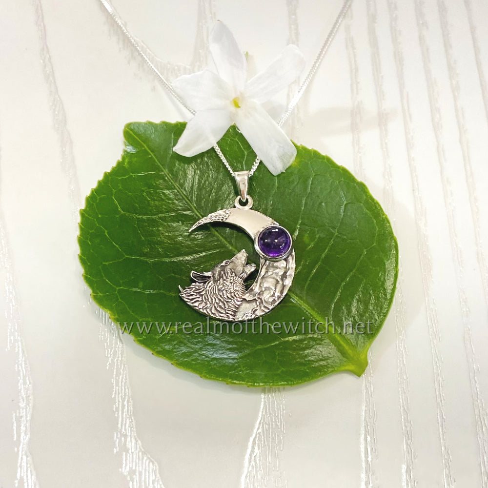 This highly polished silver necklace features a wolf howling at the moon with an amethyst cabochon. All pendants come supplied on an 20" Sterling Silver Curb Chain and are gift boxed. Now also available with a Rainbow Moonstone cabochon  Size approx: W: 2.3cm x H: 3.3cm including bale