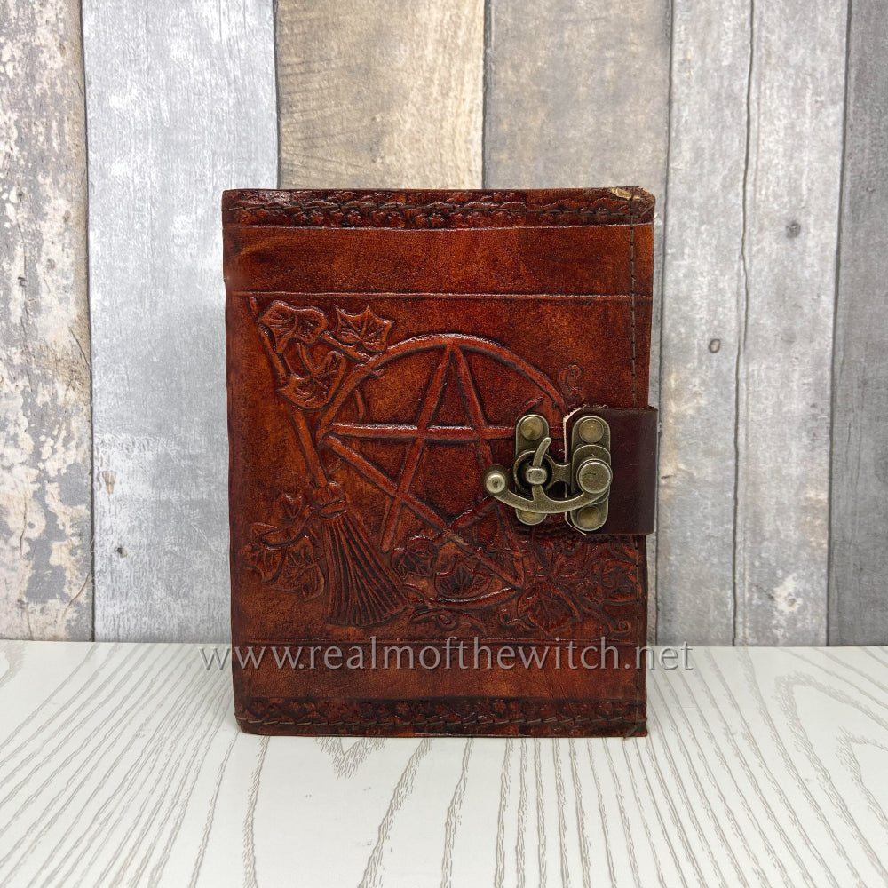 Bound in brown leather, the book comes with one metal clasp, keeping it from falling open unexpectedly. The cover is embossed with the image of a large pentacle, flanked by a broomstick and tendrils of ivy, alongside other floral offerings. Inside, high-quality plain paper gives you the freedom to record your thoughts and dreams unimpeded.
