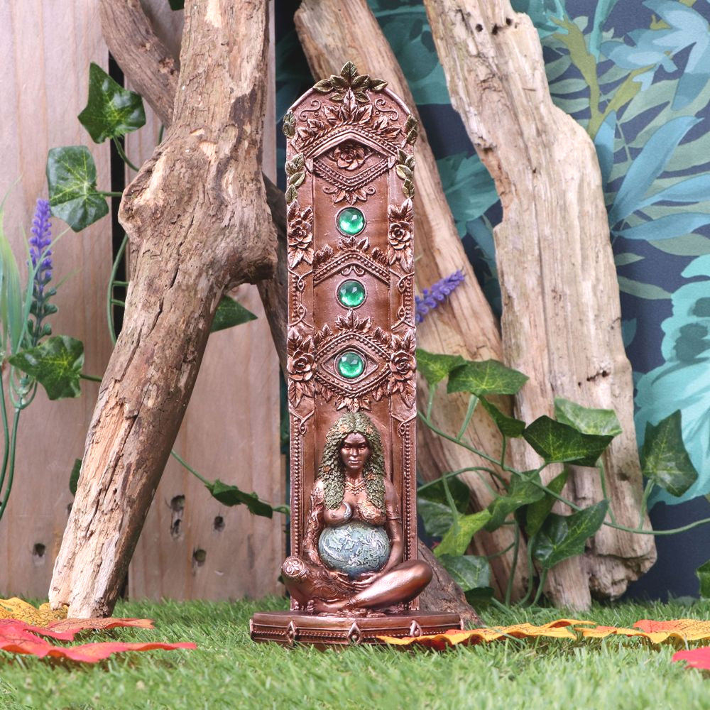Mother Earth sits peacefully at the bottom of a large floral totem, supporting the world as a pregnant belly between her bronzed decorated arms. Cascading over her shoulders and down her back, her hair is comprised of thick green foliage, adorned with intricate golden embellishments. This Mother Earth Incense Burner is cast in the finest resin before being intricately hand-painted.  Size H: 24cm Material: Polyresin
