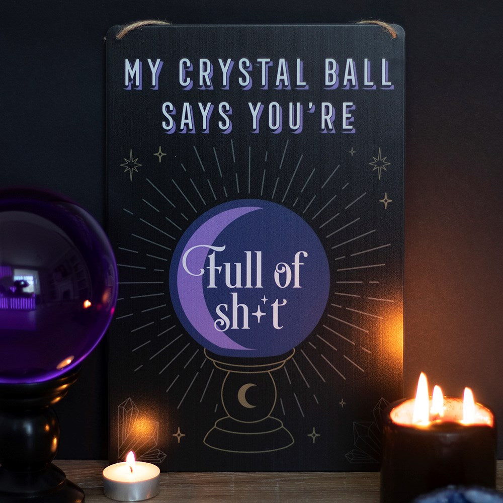 This tin sign features a trendy crystal ball design with sassy 'My crystal ball says you're full of sh*t' text within. Makes a fun piece of wall decor for witches and lovers of the strange and unusual. Strung with twine for easy hanging. Designed by Something Different and part of the Fortune Teller Range of mystical gifts and home decor.