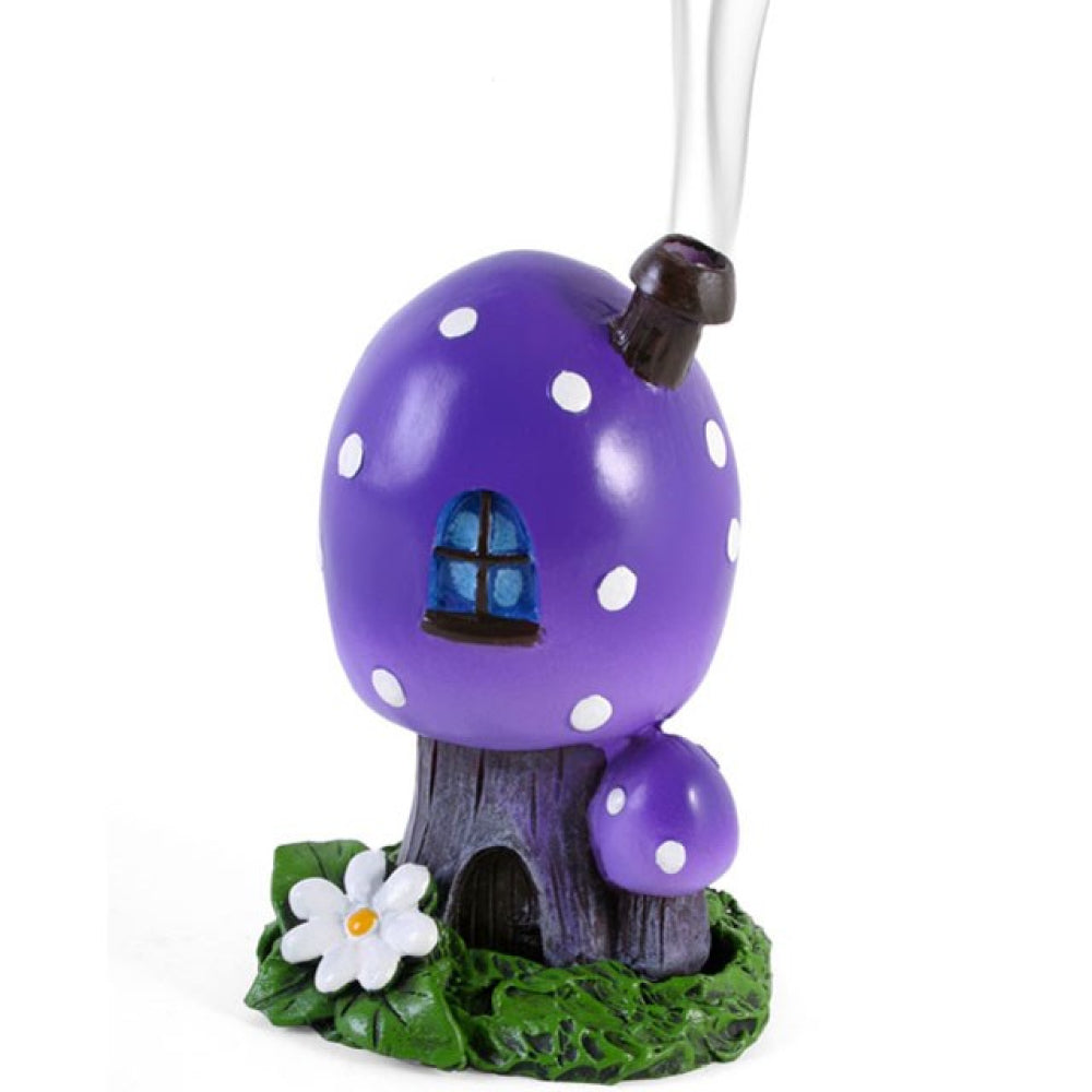 A purple toadstool house design incense cone burner. When the cone is burning, the smoke rises through the chimney of the item. Designed by Lisa Parker.
