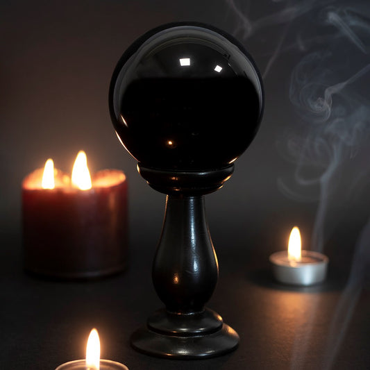 This small glass black crystal ball is not only a tool to aid in fortune telling and scrying, but also makes an eye-catching piece of décor. Comes on black wooden stand. *Warning* Keep out of direct sunlight. Material: Glass & MDF Wood Size: H: 18cm x W: 9cm x D: 9cm