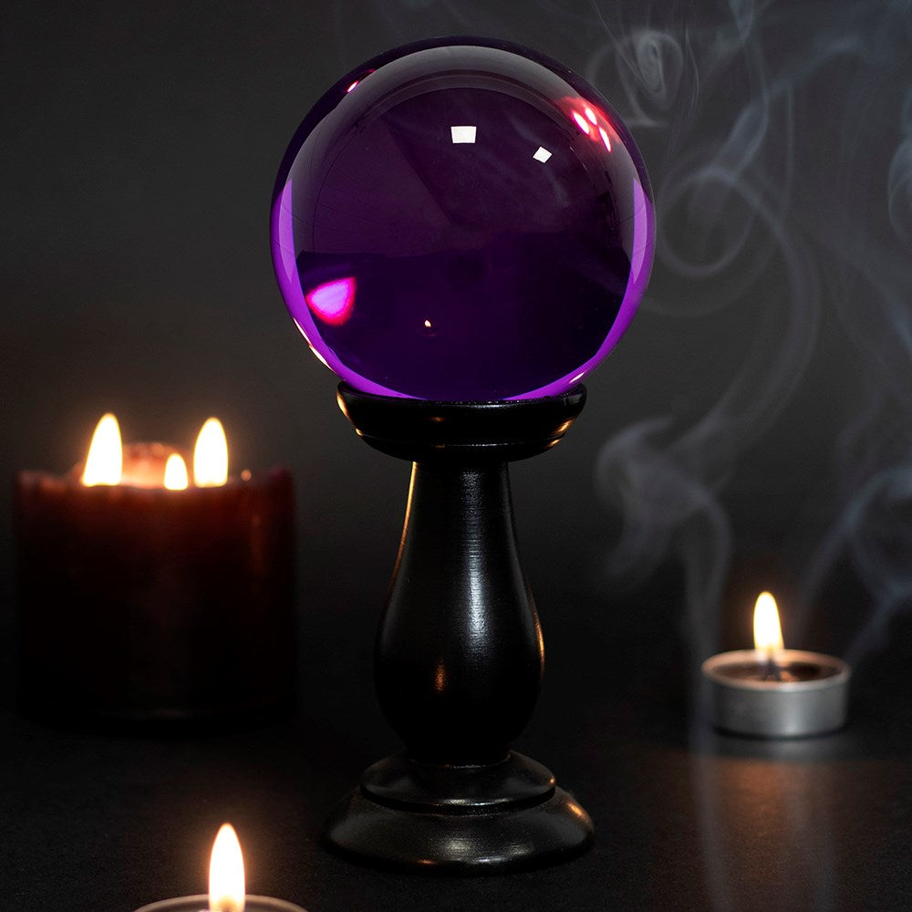 This small glass purple crystal ball is not only a tool to aid in fortune telling and scrying, but also makes an eye-catching piece of décor. Comes on black wooden stand. *Warning* Keep out of direct sunlight. Material: Glass & MDF Wood Size: H: 18cm x W: 9cm x D: 9cm