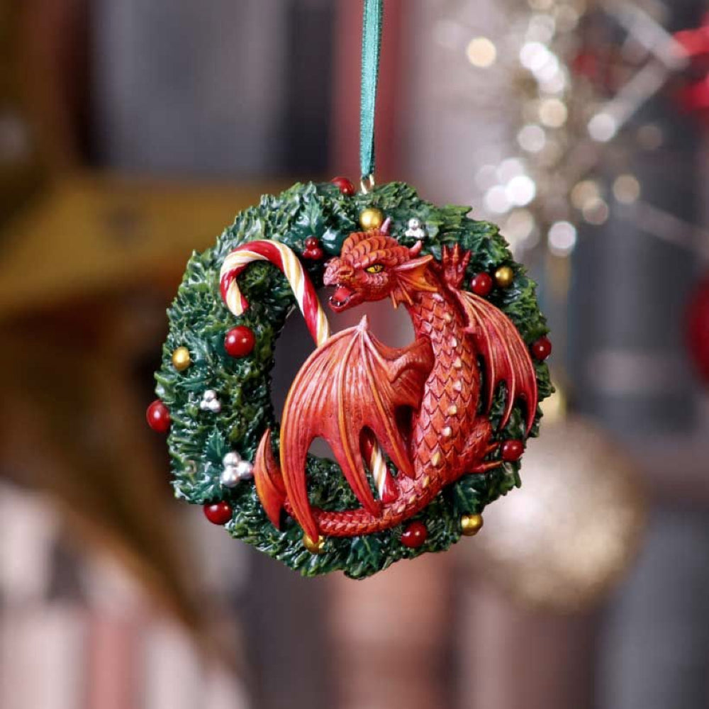 From world-renowned gothic and fantasy artist Anne Stokes, comes this Sweet Tooth Hanging Ornament.  This red dragon sure does love candy canes, they sit perched on the Christmas Wreath making sure no one takes it.  Cast in the finest resin before being expertly hand-painted, this hanging ornament will sure be a festive favourite.  Materials: Polyresin Size: H:9 cm