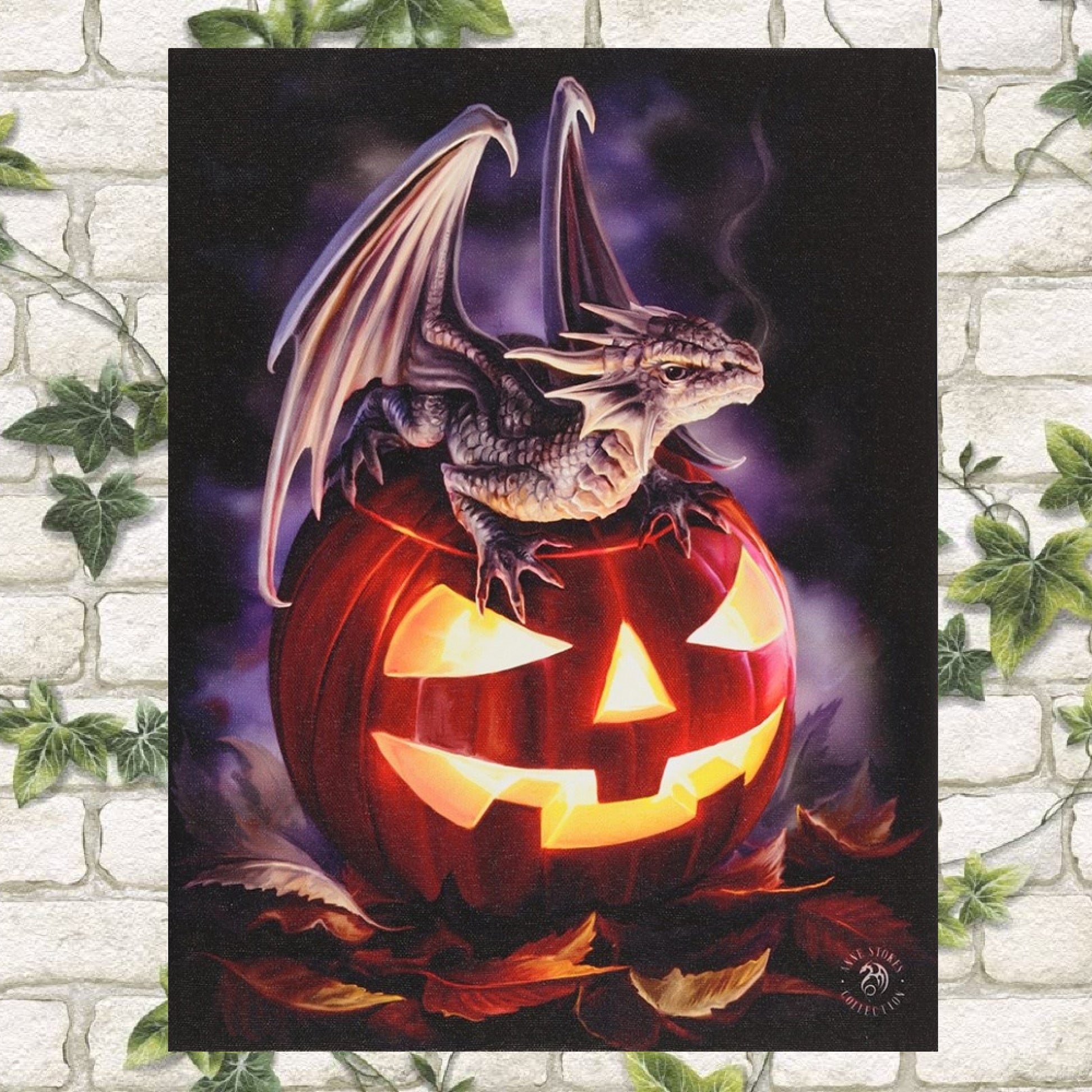 25cm x 19cm This stunningly detailed illustration is by the renowned Fantasy Artist Anne Stokes and features her Trick or Treat artwork. A dragon rests on top of a carved out jack o lantern pumpkin.