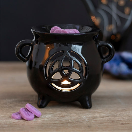 Adding to the range of the best selling Cauldron Oil Burner and the Black Cat Oil Burner, comes this sleek black glossy cauldron with a cut out triquetra design. Designed by Something Different and part of the Black Magic Collection of witchy gifts and homeware. These oil burners can also be used with wax and pair perfectly with our exclusive range on the website.  Dimension: H: 10cm x W: 13cm x D:10cm