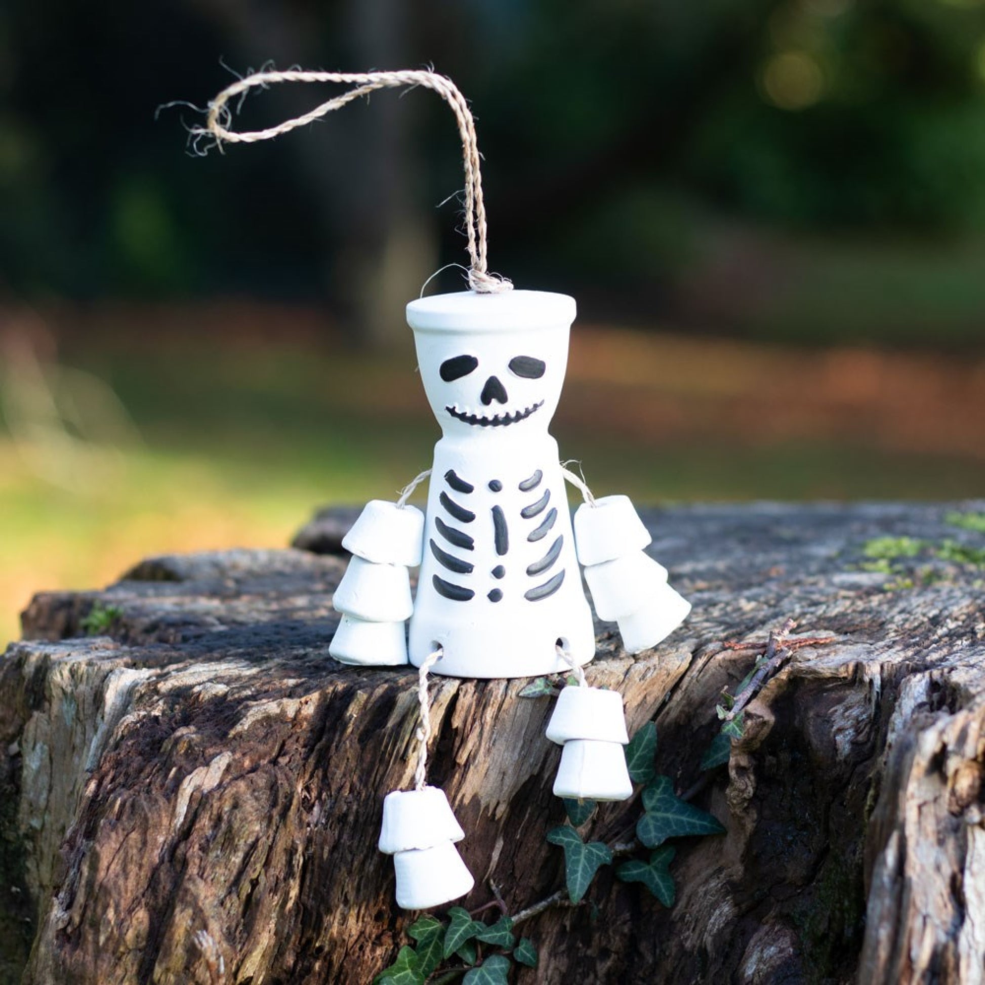Uh oh! This bestselling terracotta pot man is looking a little grim!  Spook up an outdoor space with this deadly skeleton pot man by hanging him up or having him sit on the edge of a garden wall.  A truly unique gift for the non traditional gardener. Also available on the website in black.  Dimensions H 15cm x W 5.5cm x D 11cm
